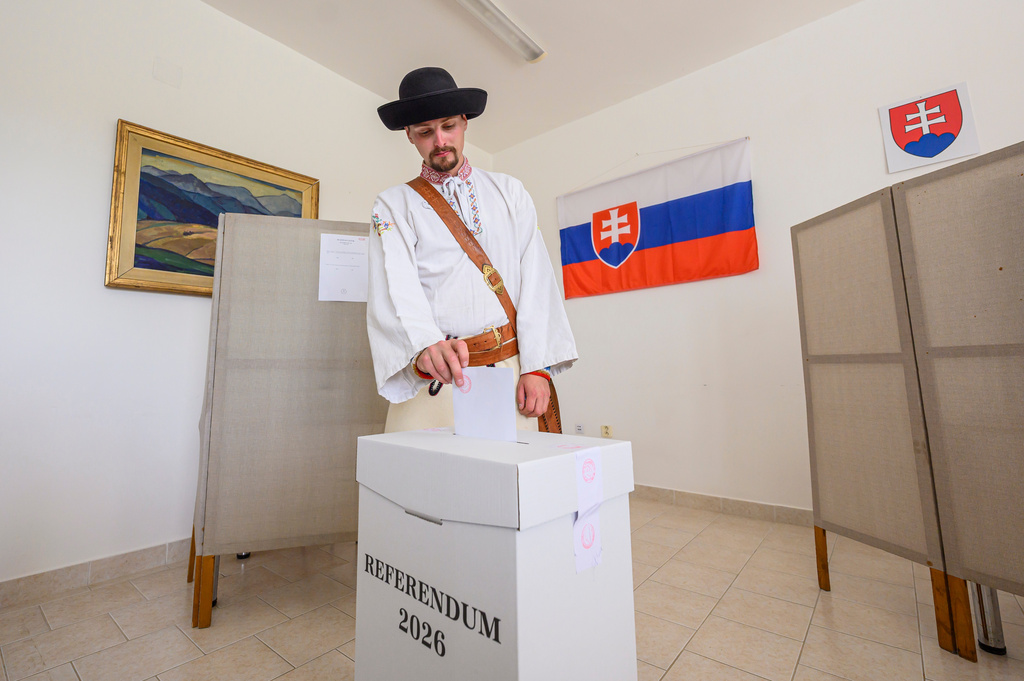 A man dressed in traditional clothing casts his ballot at a polling station, during a referendum, in Vychodna, Slovakia, Saturday, July 4, 2026. (Michal Svitok/TASR via AP)