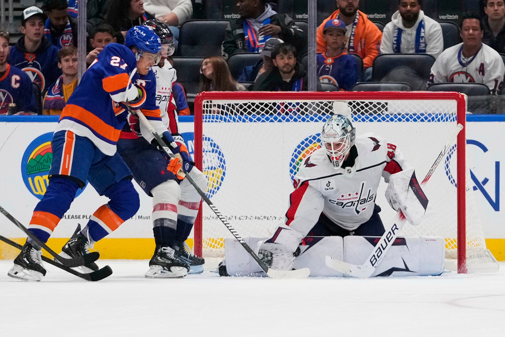 Washington Capitals goaltender Logan Thompson (48) stops a shot by New York Islanders' Anders Lee (27) during the third period of an NHL hockey game Saturday, Oct. 11, 2025, in Elmont, N.Y. (AP Photo/Frank Franklin II)