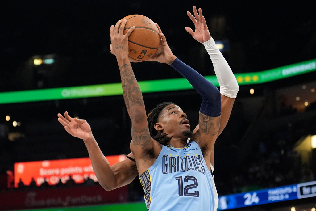 Memphis Grizzlies guard Ja Morant (12) shoots the ball during the first half of an NBA Cup basketball game against the Dallas Mavericks, Friday, Nov. 7, 2025, in Memphis, Tenn. (AP Photo/George Walker IV)