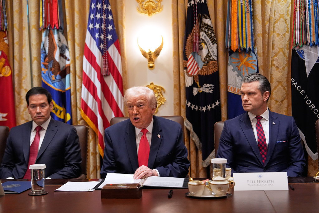 President Donald Trump speaks during a Cabinet meeting at the White House, Tuesday, Dec. 2, 2025, in Washington, as Secretary of State Marco Rubio, left, and Defense Secretary Pete Hegseth, right, look on. (AP Photo/Julia Demaree Nikhinson)