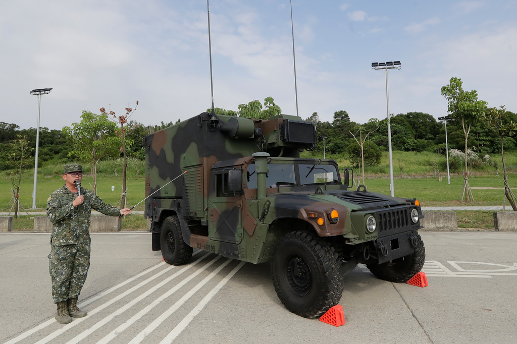 A soldier briefing a specialized HIMARS (M142 High Mobility Artillery Rocket System) command and control vehicle based on an M152A1 HMMWV during a media event in Tainan, Southern Taiwan, Tuesday, Sept. 22, 2026. (AP Photo/Chiang Ying-ying)