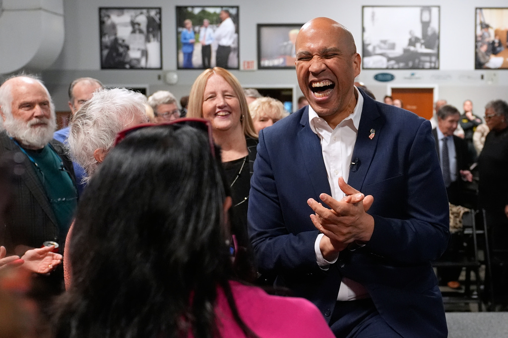 Sen. Cory Booker, D-N.J., laughs with guests during a gathering Friday, Nov. 14, 2025, in Manchester, N.H. (AP Photo/Charles Krupa)