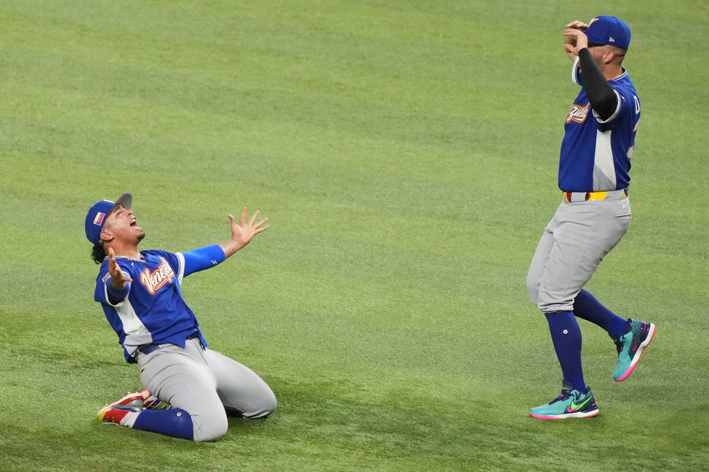 Venezuela pitcher Daniel Palencia, left, celebrates after the team defeated the United States in the championship game of the World Baseball Classic, Tuesday, March 17, 2026, in Miami. (AP Photo/Lynne Sladky)