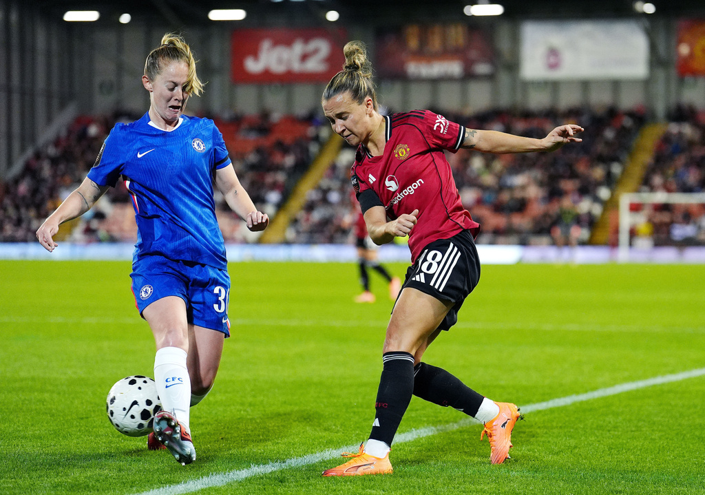 Manchester United's Julia Zigiotti Olme (right) and Chelsea's Keira Walsh battle for the ball during the Barclays Women's Super League match at the Progress With Unity Stadium in Leigh, Manchester, England, Friday Oct. 3, 2025. (Martin Rickett/PA via AP)