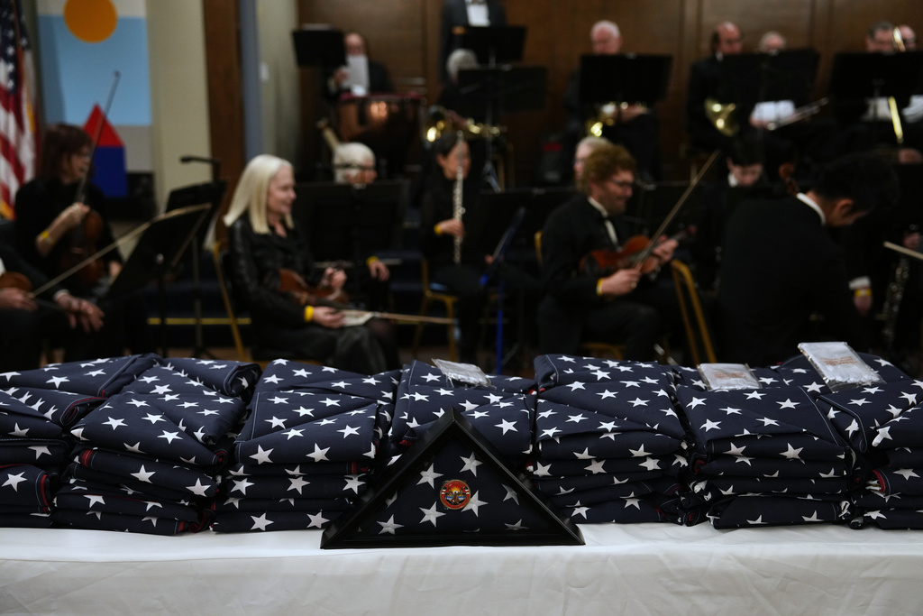 Flags in honor of fire victims are placed on a table on the one-year anniversary of the Palisades Fire in the Pacific Palisades neighborhood of Los Angeles Wednesday, Jan. 7, 2026. (AP Photo/Jae C. Hong)