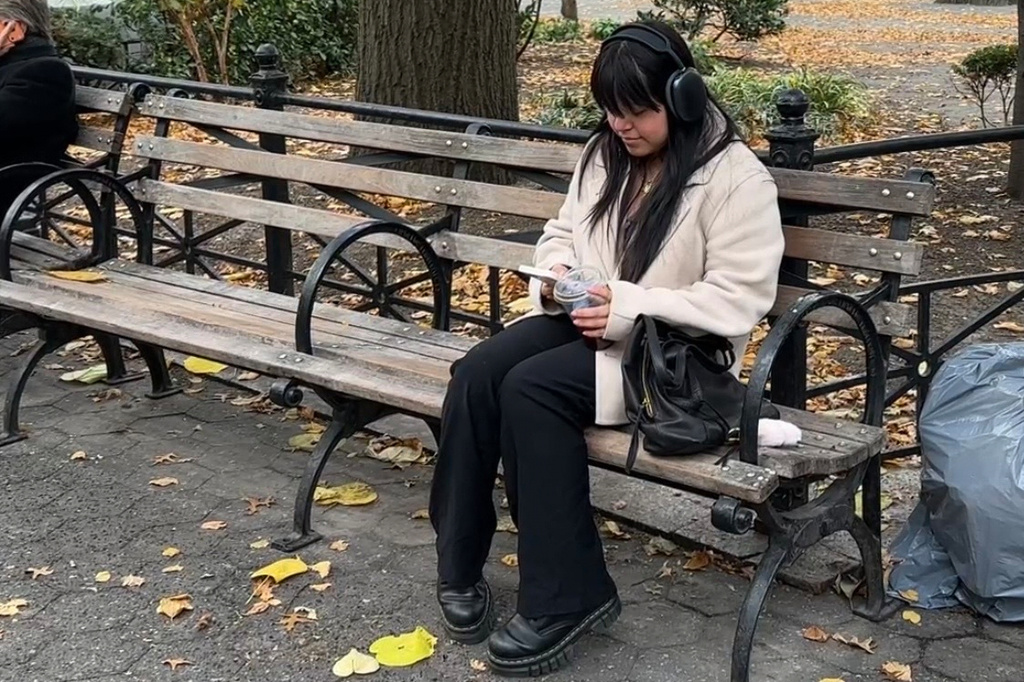 Reyna Dominguez, 18, reads in Union Square Park in Manhattan on Nov. 6, 2025. (AP Photo/Cathy Bussewitz)