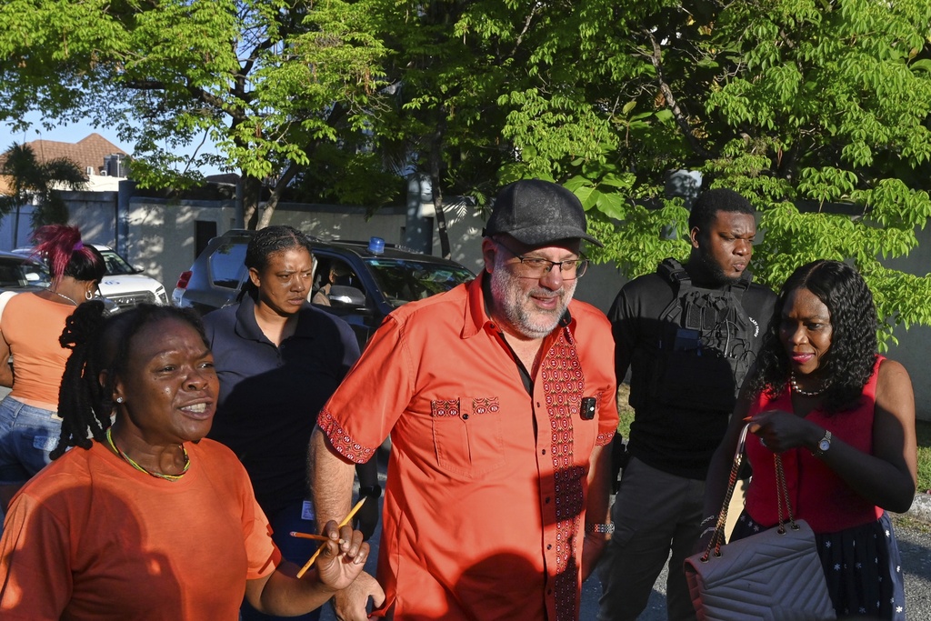 Mark Jefferson Golding, center, opposition leader and president of the People's National Party who is running for Prime Minister, walks to a polling station during general elections in Kingston, Jamaica, Wednesday, Sept. 3, 2025. (AP Photo/Collin Reid)