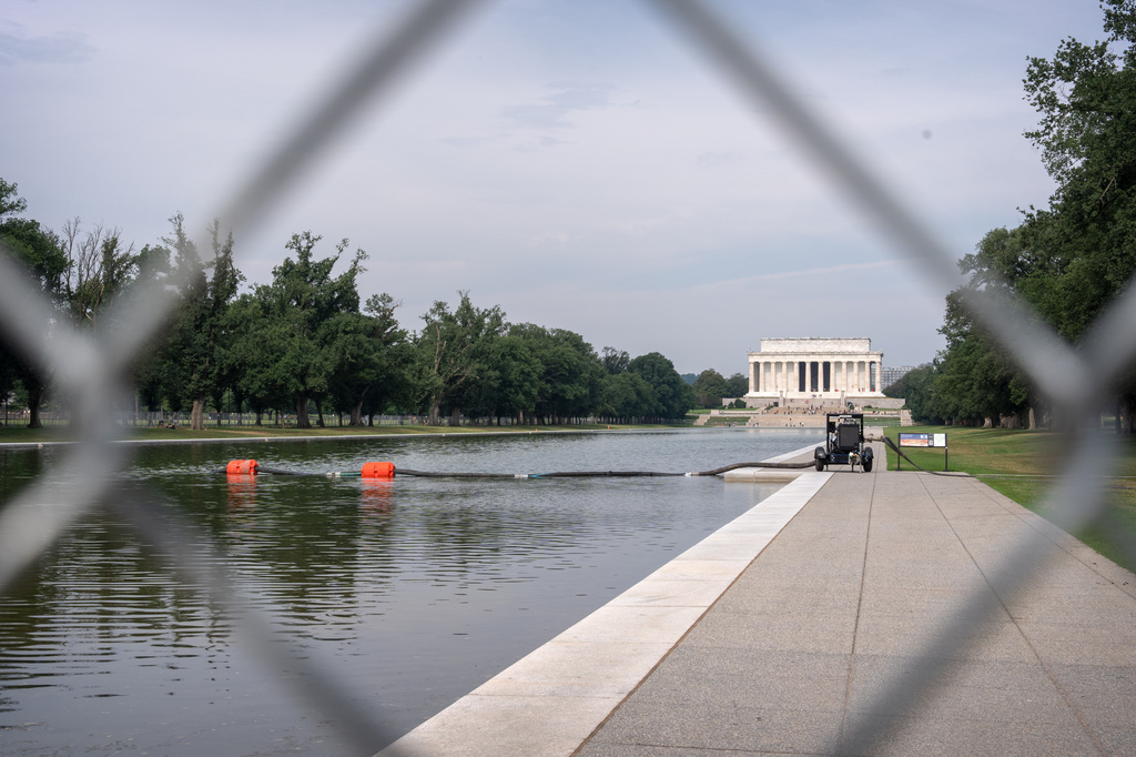 A pump connected to a hose is placed next to the Lincoln Memorial Reflecting Pool, Friday, July 10, 2026, in Washington. (AP Photo/Mark Schiefelbein)