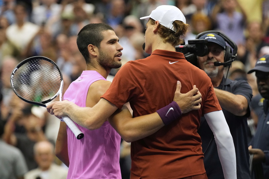 Carlos Alcaraz, of Spain, left, and Jannik Sinner, of Italy, right, embrace after their men's singles final of the U.S. Open tennis championships, Sunday, Sept. 7, 2025, in New York. (AP Photo/Seth Wenig)
