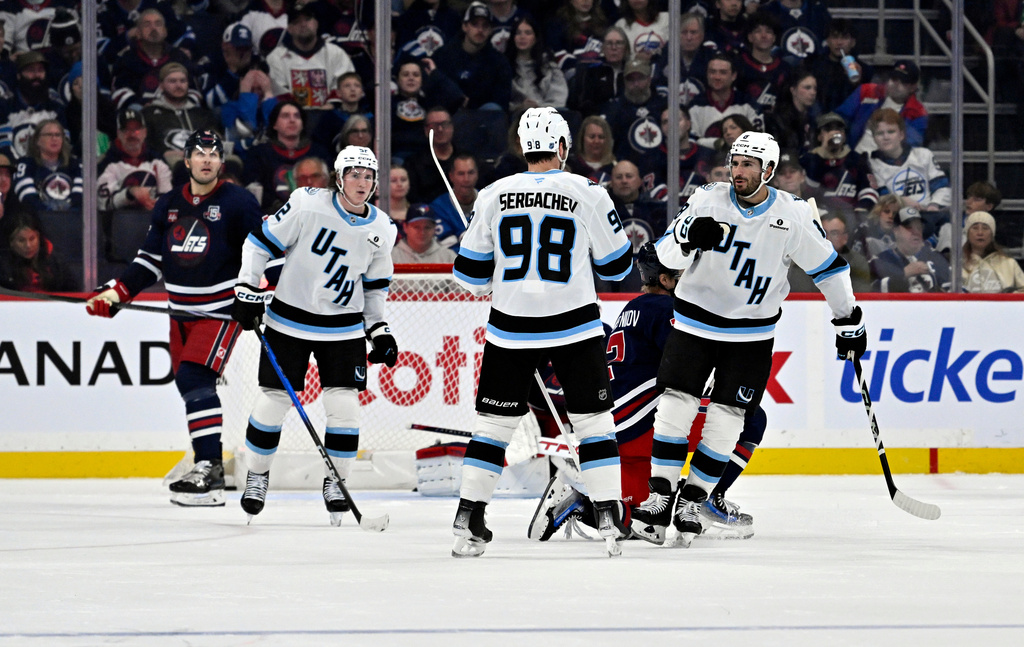 Utah Mammoth's Mikail Sergachev (98) celebrates after his goal against the Winnipeg Jets with Nick Schmaltz (8) during the second period of an NHL hockey game in Winnipeg, Manitoba, Sunday, Oct. 26, 2025. (Fred Greenslade/The Canadian Press via AP)