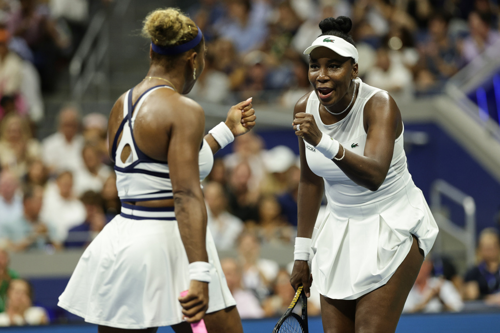 Venus Williams, right, and Serena Williams, of the United States, fist bump as they play against Hao-Ching Chan, of Taiwan, and Maya Joint, of Australia, during a women's doubles match at the U.S. Open tennis championships, Friday, Sept. 4, 2026, in New York. (AP Photo/Adam Hunger)