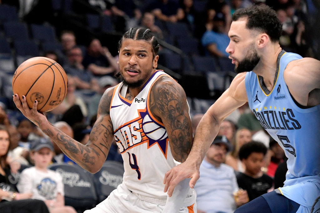 Phoenix Suns guard Jalen Green (4) handles the ball against Memphis Grizzlies forward Tyler Burton (5) in the second half of an NBA basketball game Monday, March 30, 2026, in Memphis, Tenn. (AP Photo/Brandon Dill)