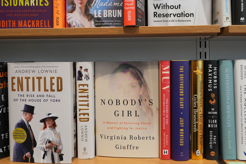 The memoir book of Virginia Giuffre, "Nobody's Girl" sits on a shelf amongst other books and is up for sale at a book store in London, Tuesday, Oct. 21, 2025 six months after Giuffre died by suicide in April.(AP Photo/Kirsty Wigglesworth)