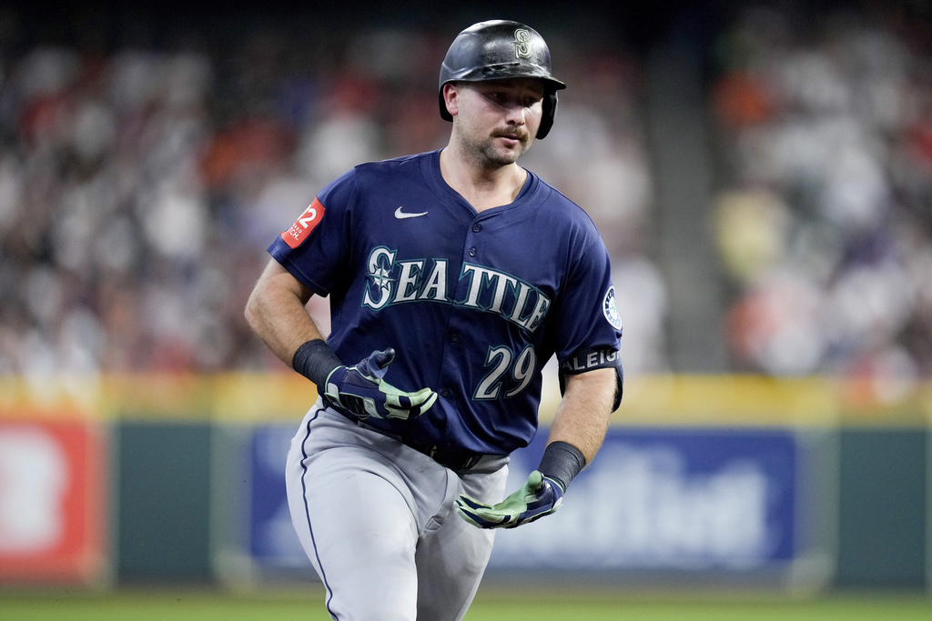 Seattle Mariners' Cal Raleigh gestures to the Mariners' dugout as he rounds the bases after hitting a solo home run, his 57th of the season, against the Houston Astros during the third inning of a baseball game Saturday, Sept. 20, 2025, in Houston. (AP Photo/Eric Christian Smith)
