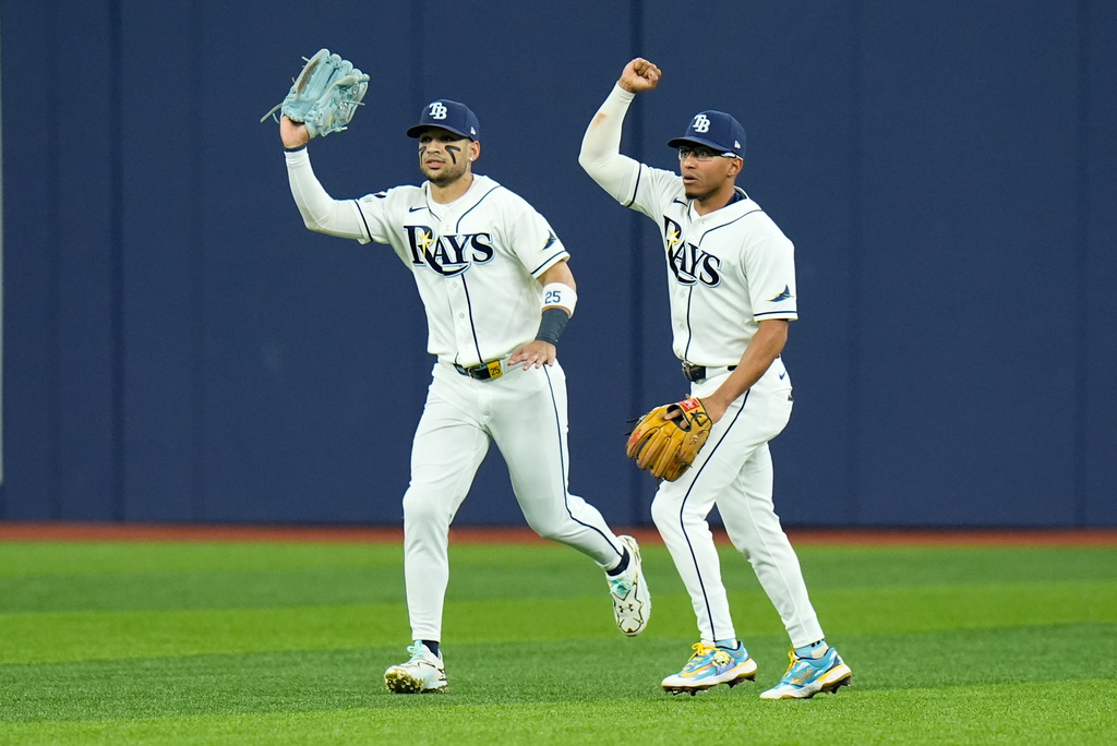 Tampa Bay Rays right fielder Victor Mesa Jr., left, and Rays second baseman Richie Palacios, right, react after Mesa Jr. caught a fly ball hit by New York Yankees' Spencer Jones that hit the ceiling of Tropicana Field for an out during the second inning in Game 2 of an American League Division Series baseball game Monday, Oct. 5, 2026, in St. Petersburg, Fla. (AP Photo/Chris O'Meara)