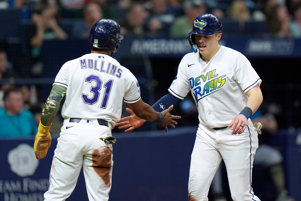 Tampa Bay Rays' Cedric Mullins (31) and Hunter Feduccia celebrate after scoring on a two-run double by Taylor Walls pff Miami Marlins pitcher Janson Junk during the fourth inning of a baseball game Friday, May 15, 2026, in St. Petersburg, Fla. (AP Photo/Chris O'Meara)