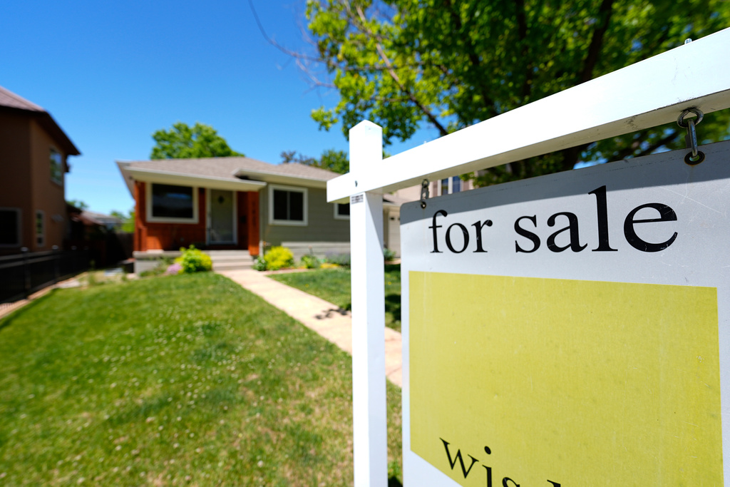 FILE - A for sale sign stands outside a single-family residence on the market May 22, 2024, in southeast Denver. (AP Photo/David Zalubowski, File)