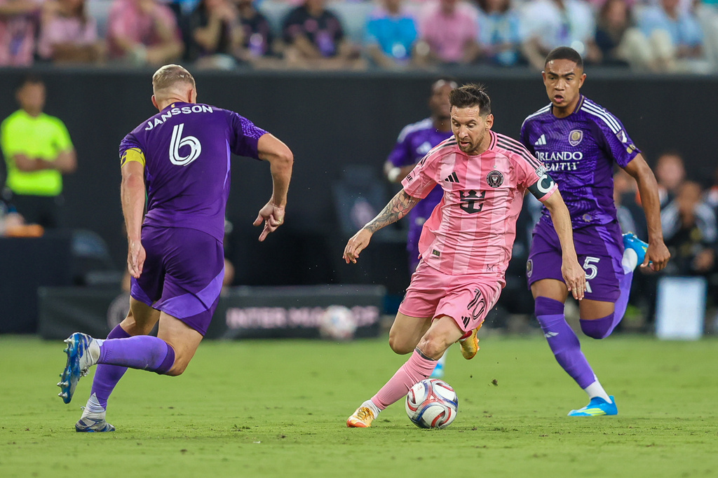 Inter Miami forward Lionel Messi (10) controls the ball as Orlando City defender Robin Jansson (6) attempts to stop and midfielder Luis Otávio (5) looks on in the first half during an MLS soccer match against the Orlando City, Saturday, May 2, 2026, in Miami. (AP Photo/Chris Arjoon)