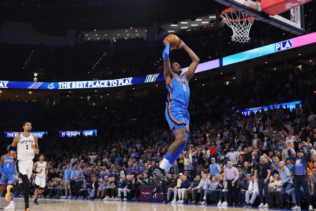 Oklahoma City Thunder guard Jalen Williams (8) goes up for a dunk in front of San Antonio Spurs forward Victor Wembanyama (1) during the second half of an NBA basketball game, Tuesday, Jan. 13, 2026, in Oklahoma City. (AP Photo/Nate Billings)