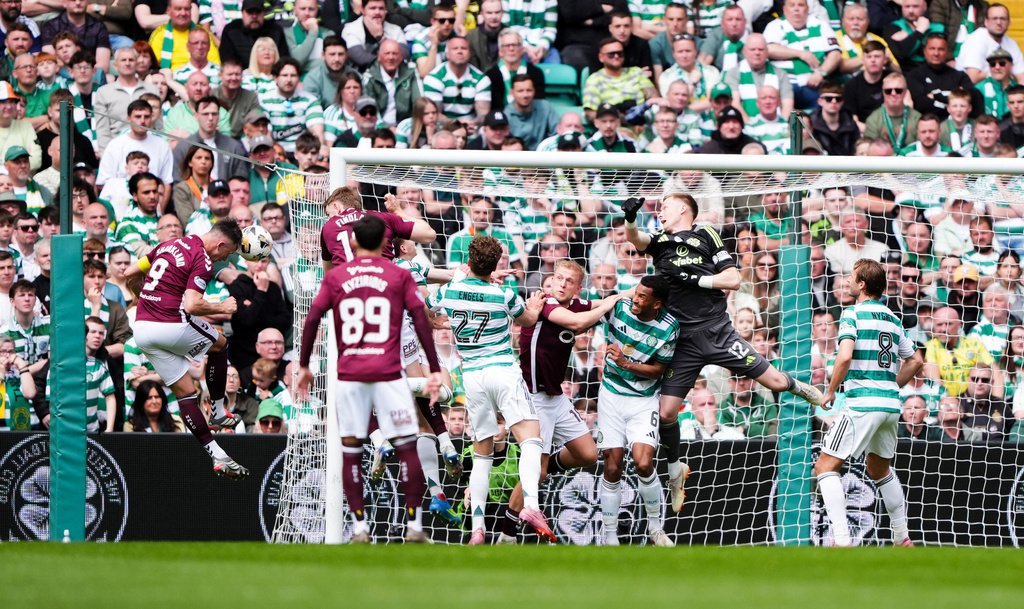 Heart of Midlothian's Lawrence Shankland, left, heads the ball to score the opening goal during the Premiership soccer match between Celtic and Heart of Midlothian, in Glasgow, Scotland, Saturday May 16, 2026. (Andrew Milligan//PA via AP)