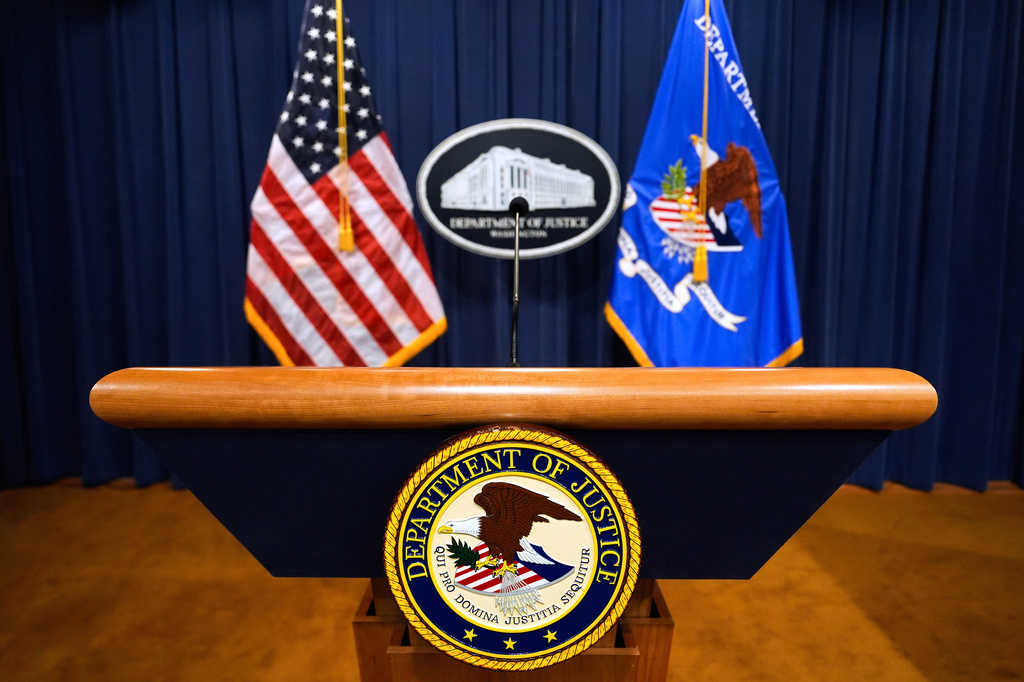FILE - The U.S. Department of Justice logo is seen on a podium before a press conference, May 6, 2025, at the Justice Department in Washington. (AP Photo/Julia Demaree Nikhinson, File)