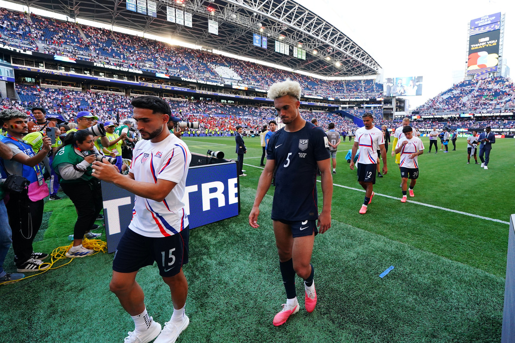 United States' Cristian Roldan (15) and United States' Antonee Robinson (5) walk off the pitch after the World Cup round of 16 soccer match between the United States and Belgium in Seattle, Monday, July 6, 2026. (AP Photo/Ted S. Warren)