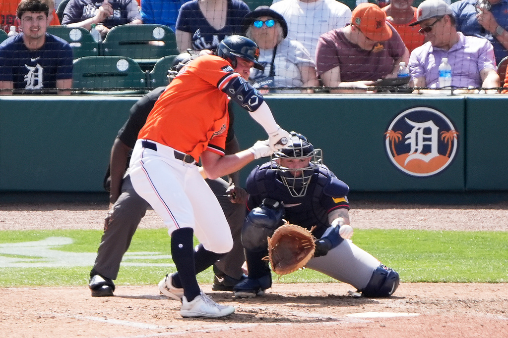 Detroit Tigers' Kerry Carpenter checks his swing against a low pitch during the fourth inning of a spring training baseball game against the Atlanta Braves, Monday, March 2, 2026, in Lakeland, Fla. (AP Photo/John Raoux)