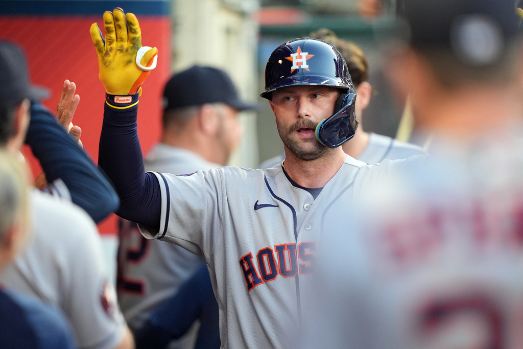 Houston Astros' Christian Walker (8) celebrates with teammates in the dugout after his home run against the Los Angeles Angels during the fourth inning of a baseball game Tuesday, July 28, 2026, in Anaheim, Calif. (AP Photo/Scott Strazzante)