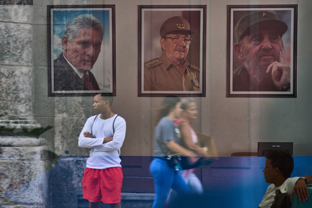 FILE- Framed images of Cuba's President Miguel Diaz-Canel, Raul Castro and Fidel Castro, adorn a state building wall in Havana, Cuba, May 20, 2026. (AP Photo/Ramon Espinosa, File)