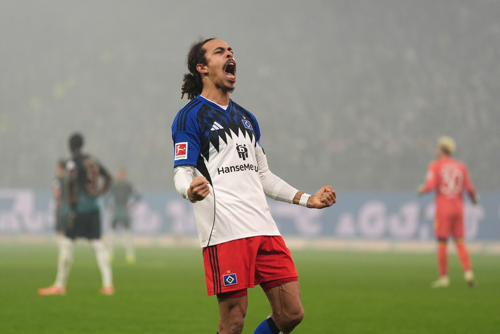 Hamburg's Yussuf Poulsen celebrates after scoring his side's third goal during the German Bundesliga soccer match between Hamburger SV and SV Werder Bremen in Hamburg, Germany, Sunday, Dec. 7, 2025. (ç/dpa via AP)