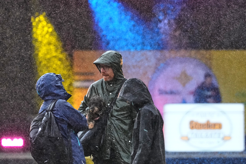 Supporters brave the heavy rain at the Steelers Tailgate event at Merrion Square ahead of the NFL football match between Minnesota Vikings and Pittsburgh Steelers in Dublin, Saturday, Sept. 27, 2025.(AP Photo/Frank Augstein)