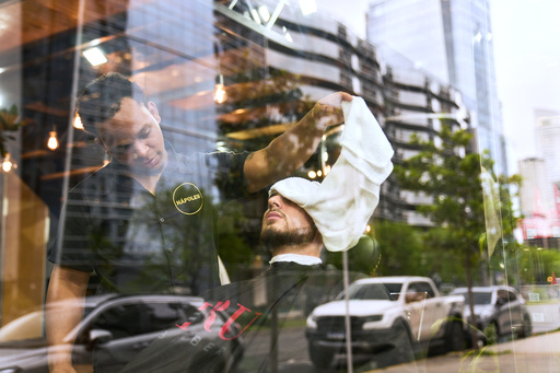 A barber tends to a customer at a barbershop in the Puerto Madero neighborhood of Buenos Aires, Argentina, Friday, Oct. 24, 2025. (AP Photo/Rodrigo Abd) A barber tends to a customer at a barbershop in the Puerto Madero neighborhood of Buenos Aires, Argentina, Friday, Oct. 24, 2025. (AP Photo/Rodrigo Abd)