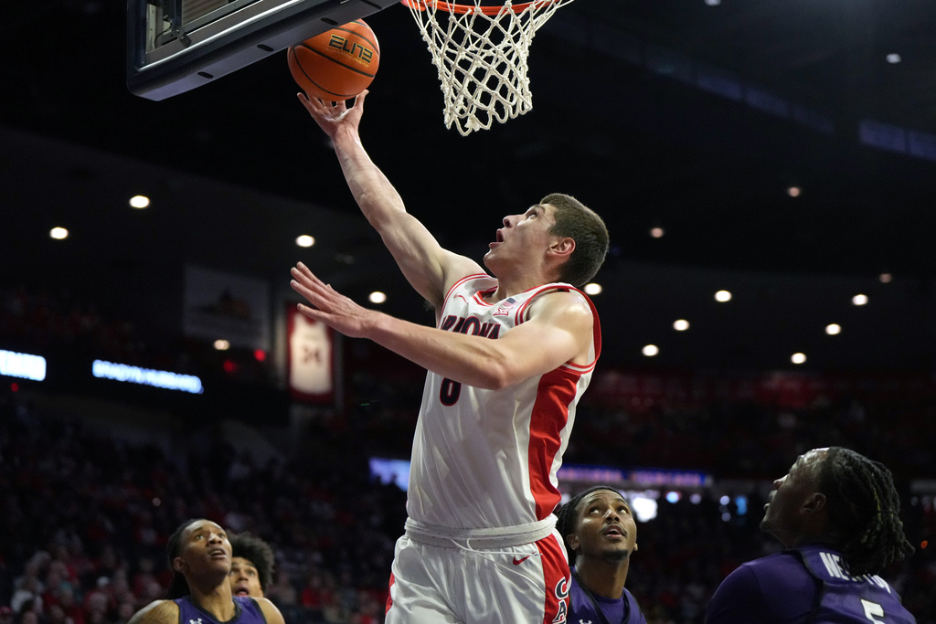 Arizona forward Ivan Kharchenkov scores against Abilene Christian during the first half of an NCAA college basketball game, Tuesday, Dec. 16, 2025, in Tucson, Ariz. (AP Photo/Rick Scuteri)