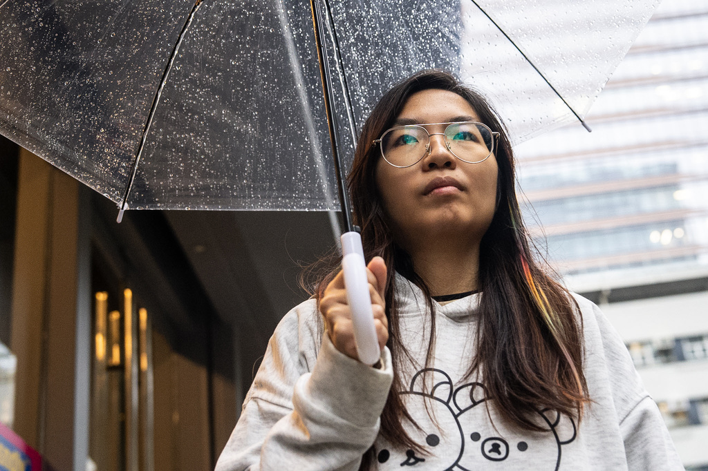 Mandy Lau, a bookseller of Have A Nice Stay bookstore, who was earlier arrested by the police, leaves a police station in Cheung Sha Wan, Hong Kong, Friday, July 17, 2026. (AP Photo/Chan Long Hei)
