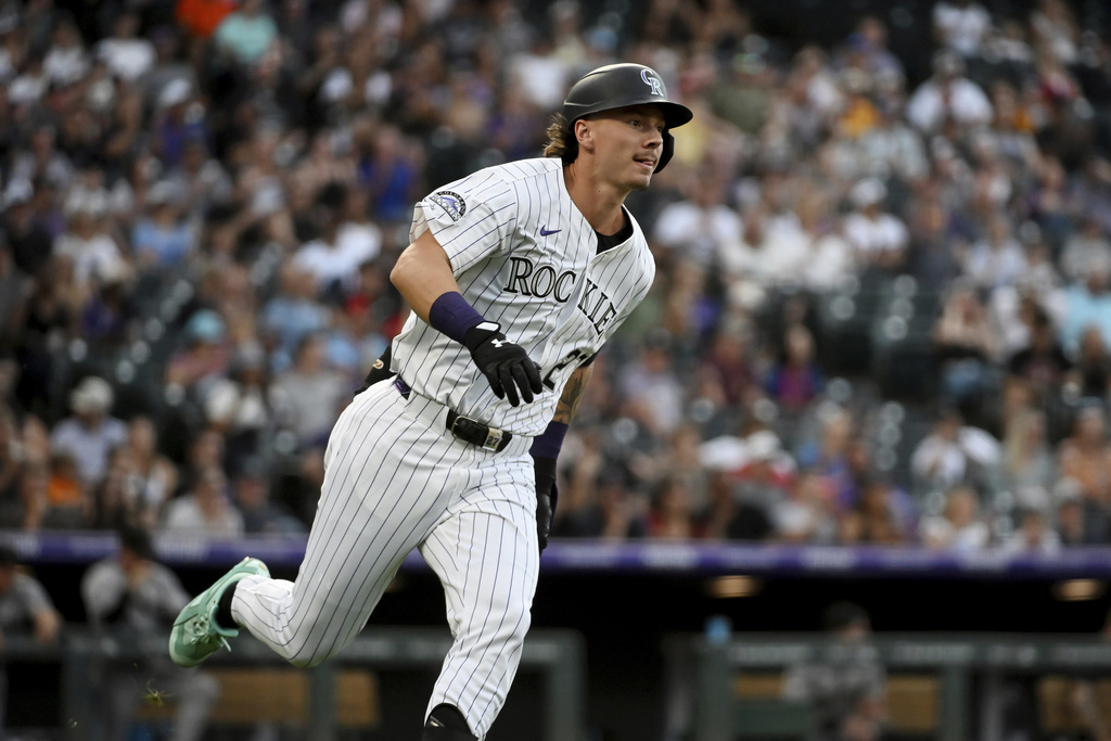 Colorado Rockies' Jordan Beck runs down the first base line on an RBI double in the third inning of a baseball game against the Arizona Diamondbacks, Saturday, Aug. 16, 2025, in Denver. (AP Photo/Geneva Heffernan)