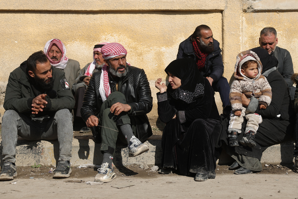 Syrian families wait outside the courthouse for the release of their children who were held at al-Aqtan prison by retreating Syrian Democratic Forces (SDF) in Raqqa, Syria, Sunday, Jan. 25, 2026. (AP Photo/Ghaith Alsayed)