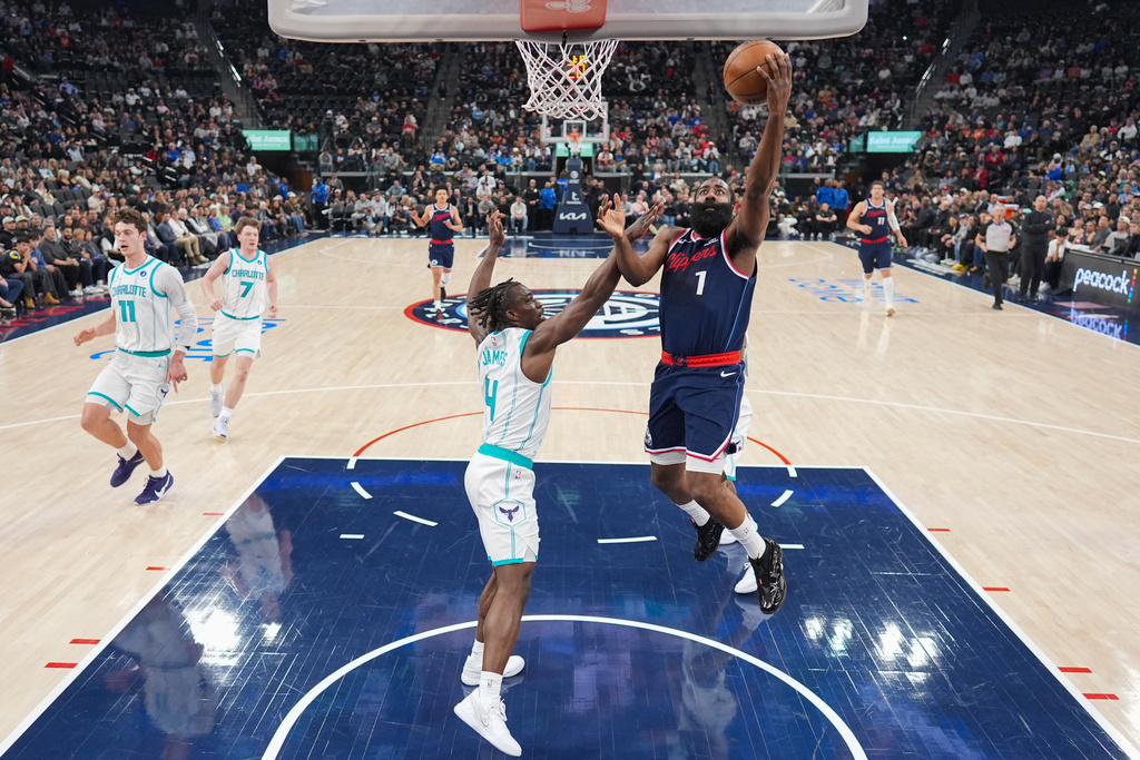 Los Angeles Clippers guard James Harden (1) shoots over Charlotte Hornets guard Sion James (4) during the first half of an NBA basketball game Monday, Jan. 12, 2026, in Inglewood, Calif. (AP Photo/Jae C. Hong)