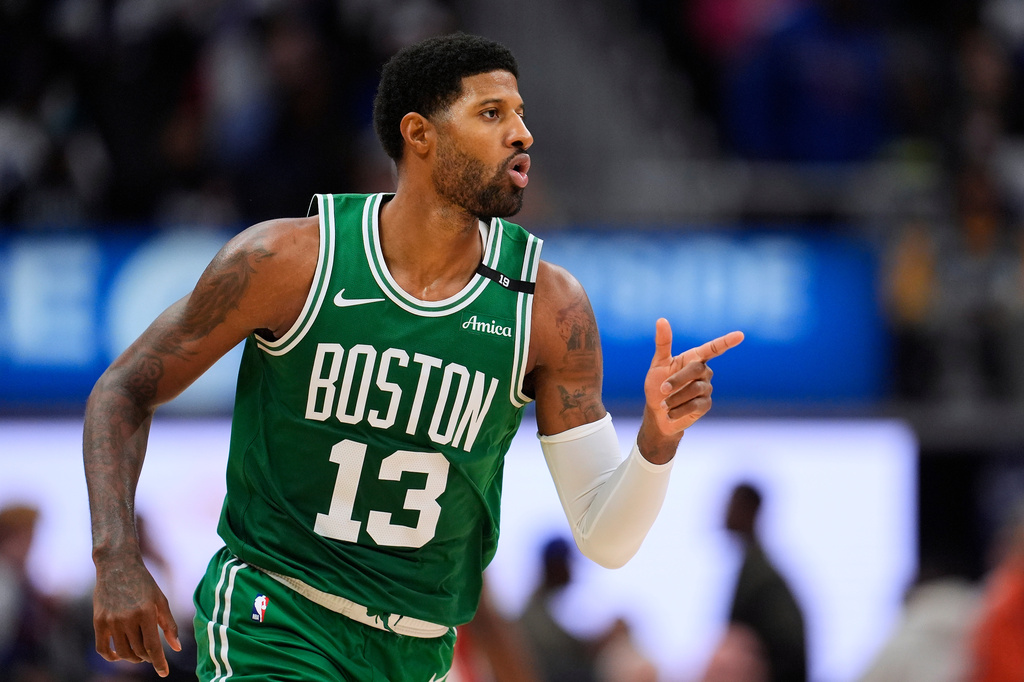 Boston Celtics forward Paul George (13) points after hitting a shot against the Detroit Pistons in the second half of an NBA basketball game in Detroit, Tuesday, Oct. 20, 2026. (AP Photo/Paul Sancya)