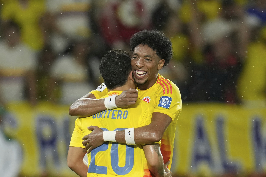 Colombia's Juan Fernando Quintero (20) celebrates with teammate Johan Mojica after scoring his side's third goal against Bolivia during a World Cup 2026 qualifying soccer match at Metropolitano stadium in Barranquilla, Colombia, Thursday, Sept. 4, 2025. (AP Photo/Fernando Vergara)