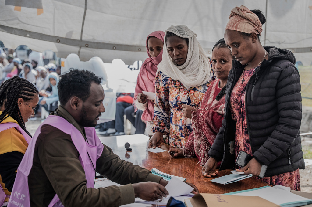 Ethiopian women collect ballot papers at a polling station during the general election in Addis Ababa, Ethiopia, Monday, June 1, 2026. (AP Photo/Amanuel Sileshi)