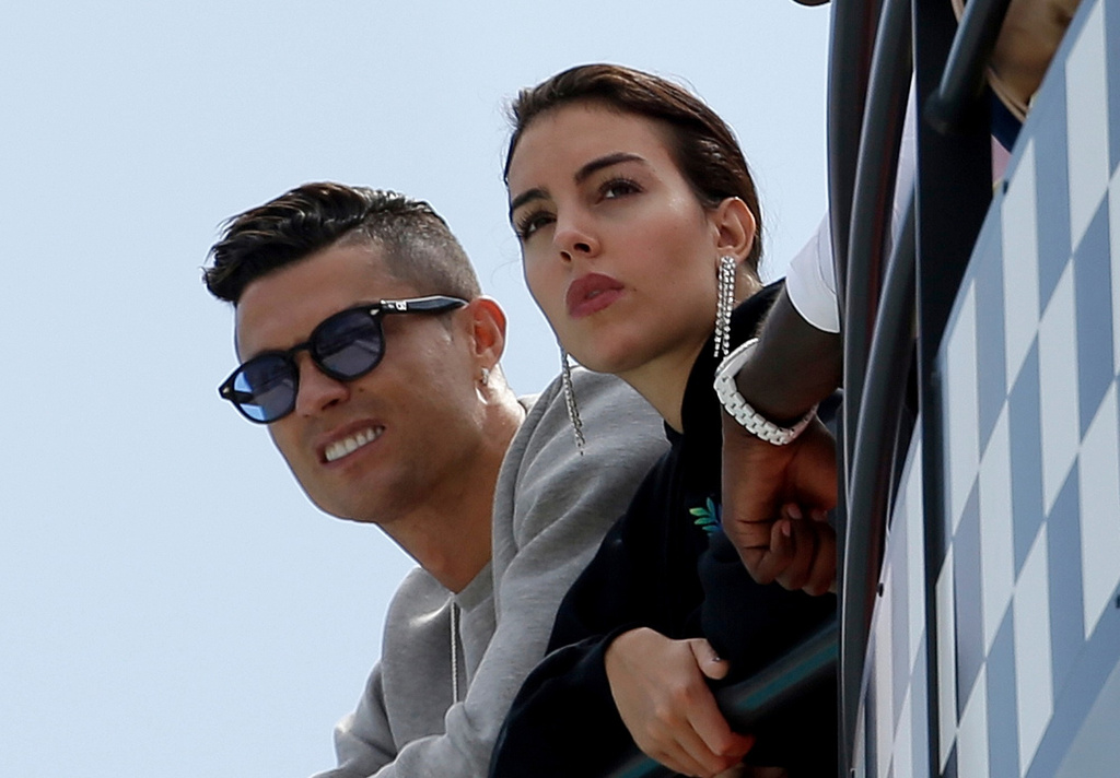 FILE - Cristiano Ronaldo, left, and his partner Georgina Rodriguez watch the second practice session at the Monaco racetrack, in Monaco, May 23, 2019. (AP Photo/Luca Bruno, File)