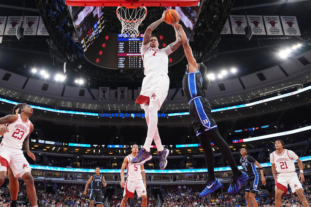 Arkansas forward Trevon Brazile (7) battles for a rebound against Duke forward Maliq Brown, center right, during the first half of an NCAA college basketball game in the CBS Sports Thanksgiving Classic tournament Thursday, Nov. 27, 2025, in Chicago. (AP Photo/Nam Y. Huh)