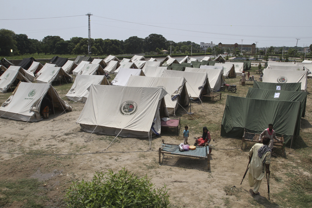 People, who fled from their homes due to flood, take shelter at a relief camp on the outskirts of Multan, Pakistan, Tuesday, Sept. 2, 2025. (AP Photo/Asim Tanveer)