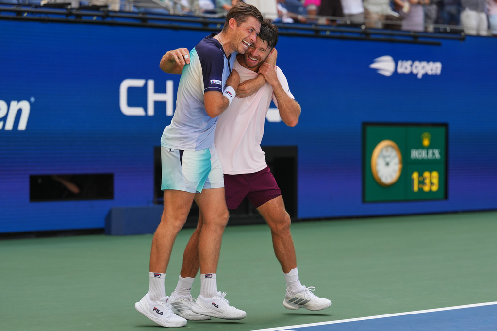 Neal Skupski, of Britain, left, celebrates with Christian Harrison, of the United States, right, after winning the men's doubles final of the U.S. Open tennis championships Kevin Krawietz, of Germany, and Tim Puetz, of Germany, Saturday, Sept. 12, 2026, in New York. (AP Photo/Kirsty Wigglesworth)