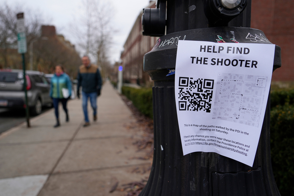 A poster seeking information about the campus shooting suspect is seen on the campus of Brown University, Wednesday, Dec. 17, 2025, in Providence, R.I. (AP Photo/Robert F. Bukaty)