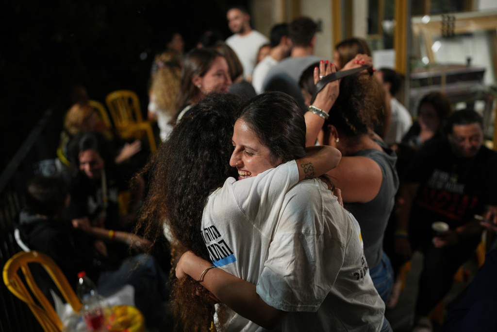Relatives and supporters of Israeli hostages held by Hamas in the Gaza Strip celebrate after the announcement that Israel and Hamas have agreed to the first phase of a peace plan, as they gather at a plaza known as the hostages square in Tel Aviv, Israel, Thursday, Oct. 9, 2025. (AP Photo/Emilio Morenatti)
