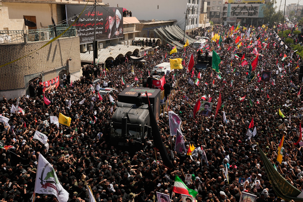 A truck carrying the coffin of the late Iranian Supreme Leader Ayatollah Ali Khamenei makes its way through mourners during a funeral procession in Najaf, Iraq, Wednesday, July 8, 2026. (AP Photo/Hadi Mizban)