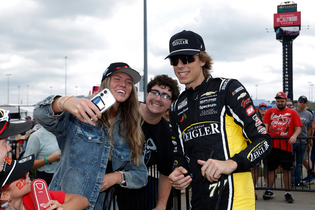 Carson Hocevar, right, interacts with fans before a NASCAR Cup Series auto race in Kansas City, Kan., Sunday, Sept. 27, 2026. (AP Photo/Colin E. Braley)