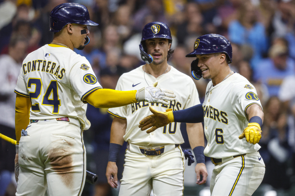 Milwaukee Brewers' Isaac Collins(10) reacts with William Contreras (24) after his three-run home run during the first inning of a baseball game against the Philadelphia Phillies, Wednesday, Sept. 3, 2025, in Milwaukee. (AP Photo/Jeffrey Phelps)