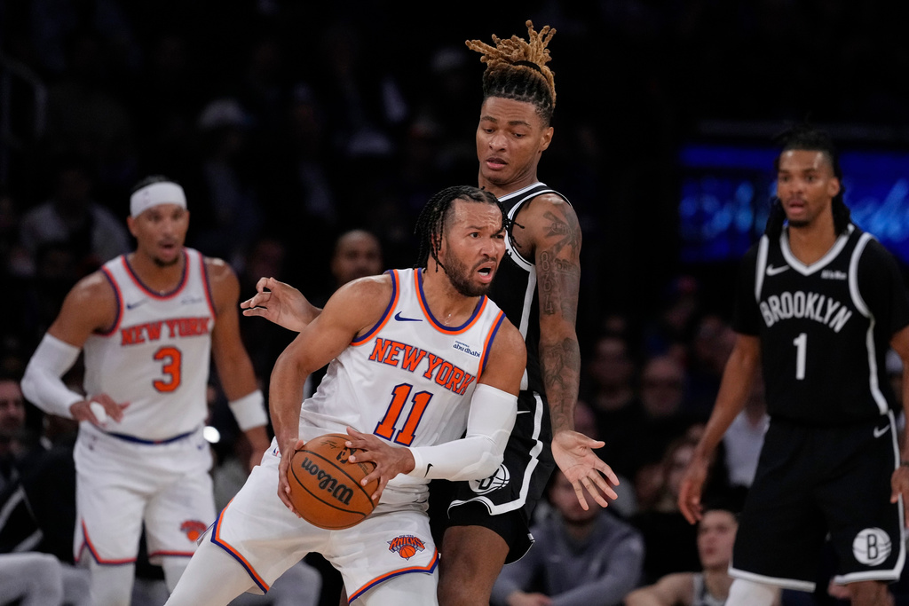 New York Knicks' Og Anunoby (8) knocks the ball away from Brooklyn Nets' Tyrese Martin (13) during the second half of an NBA basketball game Sunday, Nov. 9, 2025, at Madison Square Garden in New York. (AP Photo/Frank Franklin II)